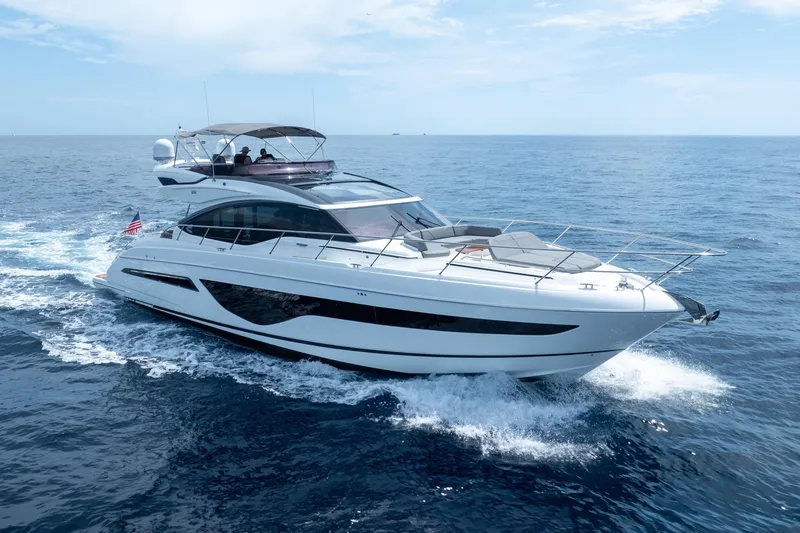 Slide: The Image of 2023 Princess S66 Sportbridge yacht cruising on open sea under clear skies. - 34