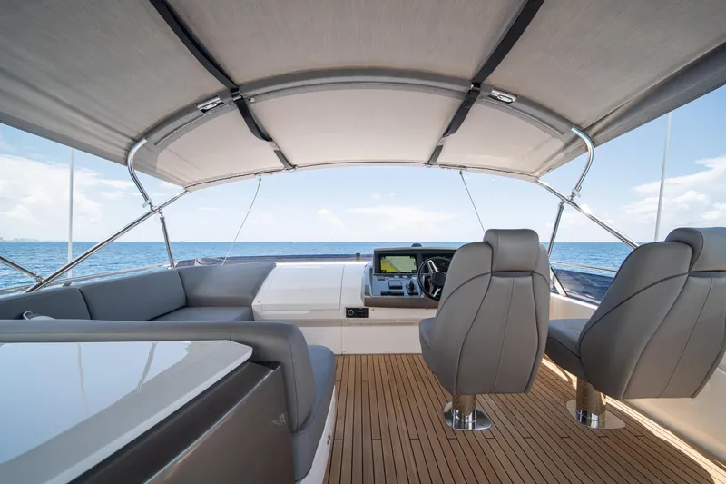 Slide: The Image of Luxurious 2023 Princess S66 Sportbridge yacht interior with sleek seating and ocean view. - 29