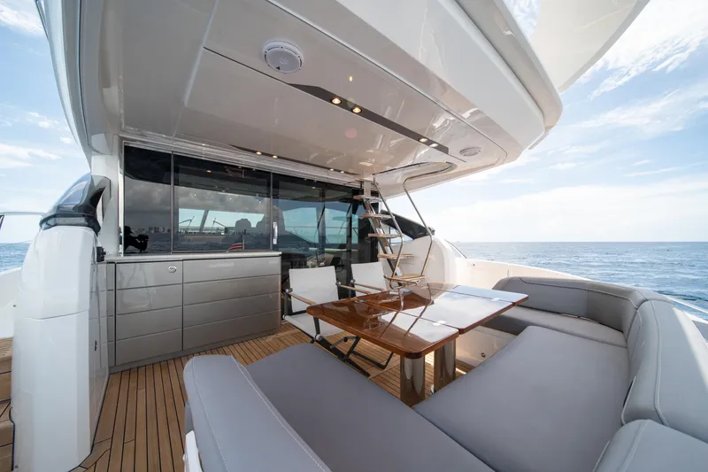 Slide: The Image of Luxurious 2023 Princess S66 Sportbridge yacht deck with elegant seating and ocean view. - 6