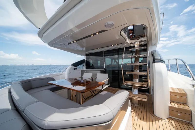Slide: The Image of Luxurious 2023 Princess S66 Sportbridge yacht with elegant outdoor seating and ocean view. - 4