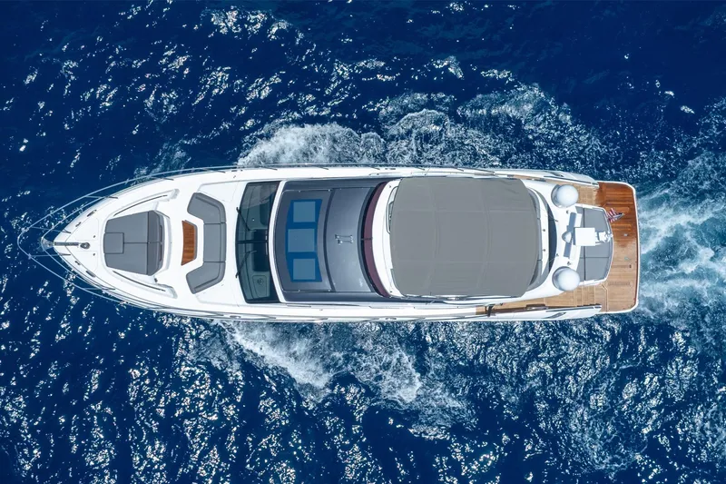 Slide: The Image of Aerial view of 2023 Princess S66 Sportbridge yacht cruising on blue ocean waters. - 2