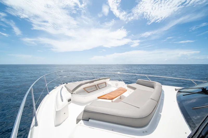 Slide: The Image of 2023 Princess S66 Sportbridge yacht with luxurious deck seating, ocean view. - 32