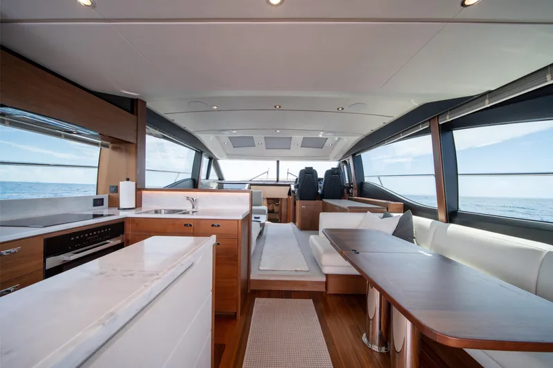Slide: The Image of Luxurious interior of 2023 Princess S66 Sportbridge yacht with modern kitchen and seating area. - 9