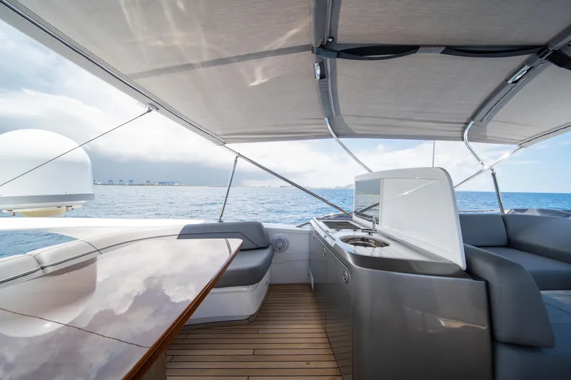 Slide: The Image of Luxurious 2023 Princess S66 Sportbridge yacht deck with seating and ocean view. - 28