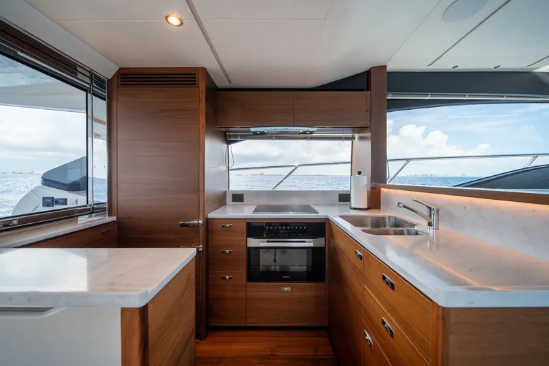 Slide: The Image of Luxurious kitchen interior of 2023 Princess S66 Sportbridge yacht with modern appliances and ocean view. - 12