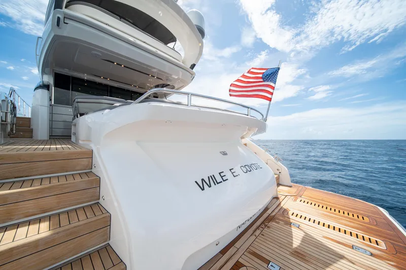Slide: The Image of 2023 Princess S66 Sportbridge yacht with American flag, ocean view, and teak deck. - 3