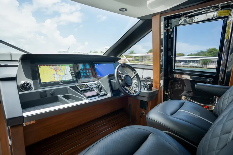 Slide: The Image of Luxurious 2023 Princess S66 Sportbridge yacht cockpit with advanced navigation systems and plush seating. - 16