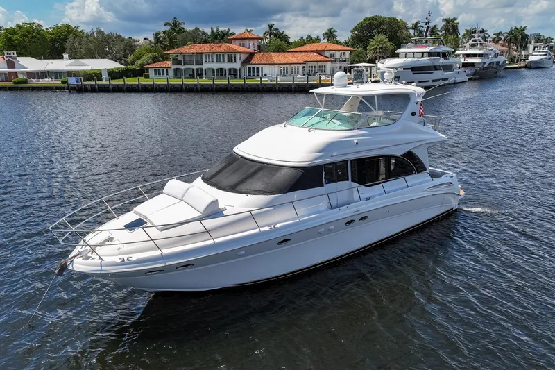 Slide: The Image of 2001 Sea Ray 540 Cockpit Motor Yacht cruising on a scenic waterway. - 2