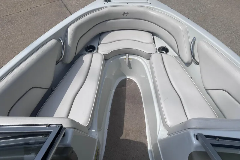 Slide: The Image of Interior view of a 2015 Crownline 21 SS boat with white cushioned seating. - 13