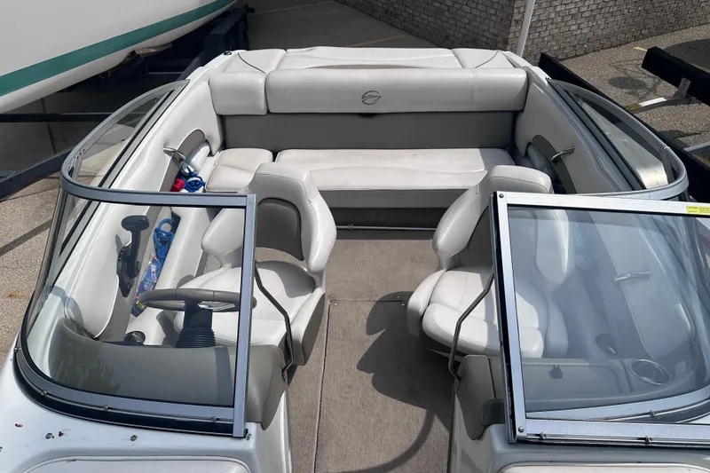 Slide: The Image of 2015 Crownline 21 SS boat interior with seating and steering wheel. - 14