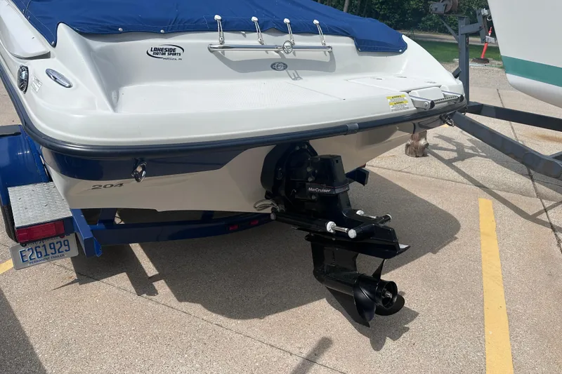 Slide: The Image of 2015 Crownline 21 SS boat on trailer, featuring MerCruiser engine and blue cover. - 5