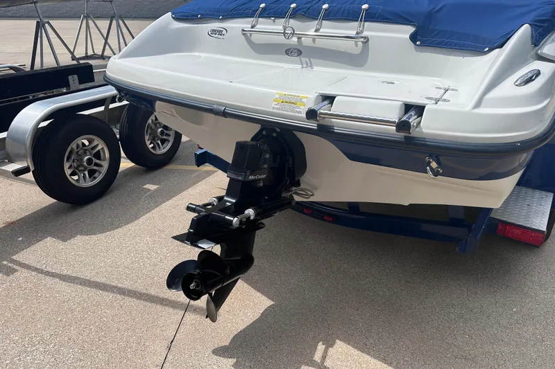 Slide: The Image of 2015 Crownline 21 SS boat with trailer, featuring a MerCruiser outboard motor. - 7