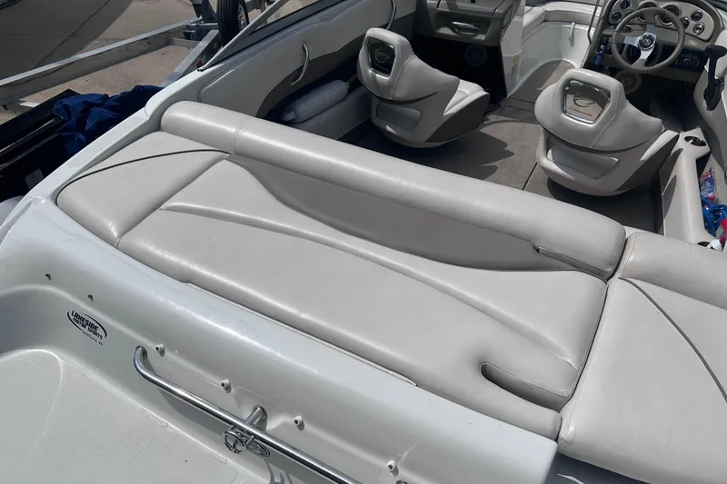 Slide: The Image of Interior of a 2015 Crownline 21 SS boat with white leather seating. - 8