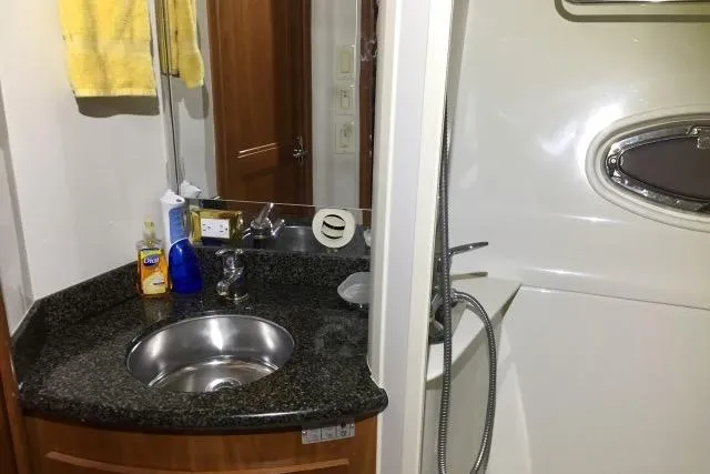 Slide: The Image of 2004 Carver 420 Mariner bathroom with sink, mirror, and shower area. - 15