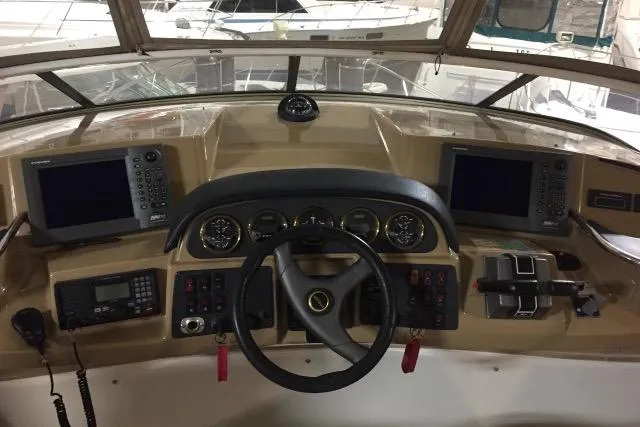 Slide: The Image of Helm of 2004 Carver 420 Mariner yacht with navigation instruments and steering wheel. - 18