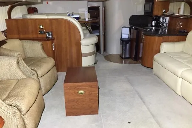 Slide: The Image of Interior of 2004 Carver 420 Mariner yacht with seating, table, and kitchenette. - 5