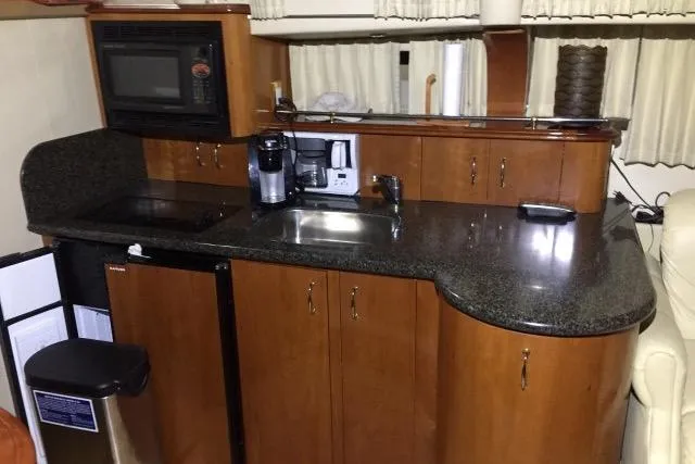 Slide: The Image of 2004 Carver 420 Mariner kitchen with microwave, sink, and coffee maker on granite countertop. - 7