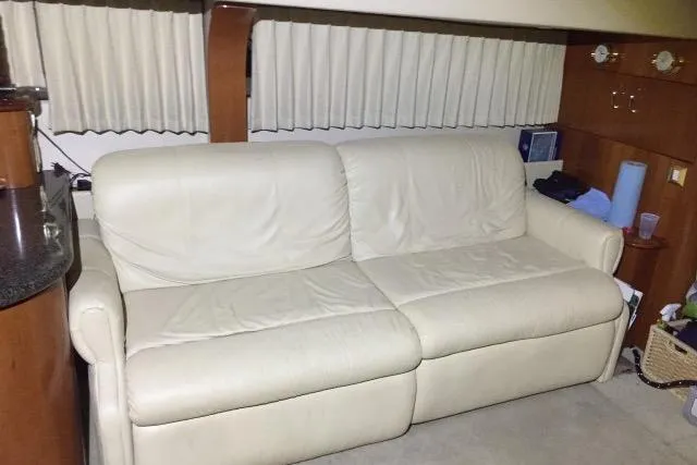 Slide: The Image of Cream leather sofa inside a 2004 Carver 420 Mariner yacht, with wooden accents and curtains. - 8