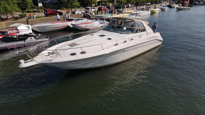 Slide: The Image of 1995 Sea Ray 450 Sundancer yacht docked in a busy marina. - 2