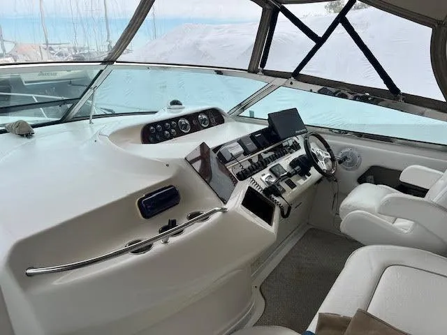 Slide: The Image of Interior helm of 1995 Sea Ray 450 Sundancer yacht with modern controls and seating. - 4
