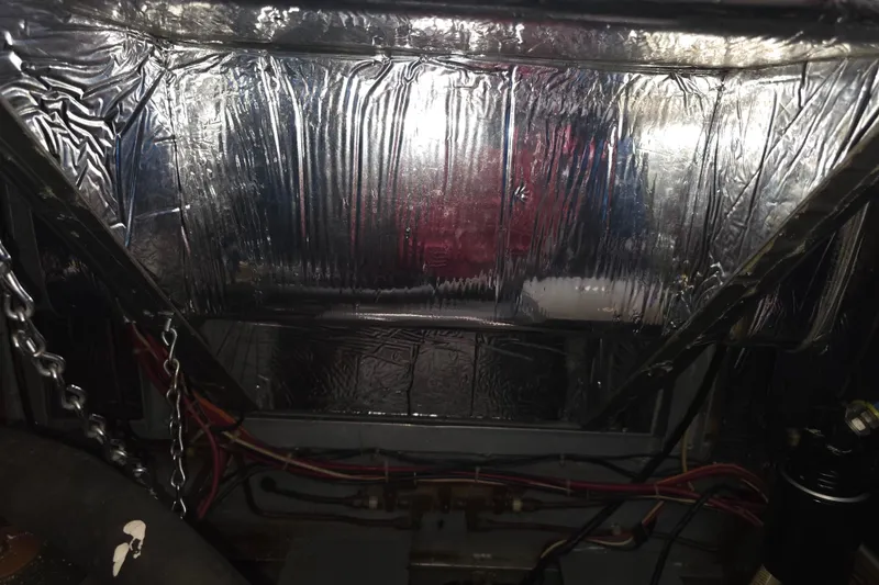 Slide: The Image of Engine room of 1988 Marinette 37 Motor Yacht with insulation and wiring visible. - 42