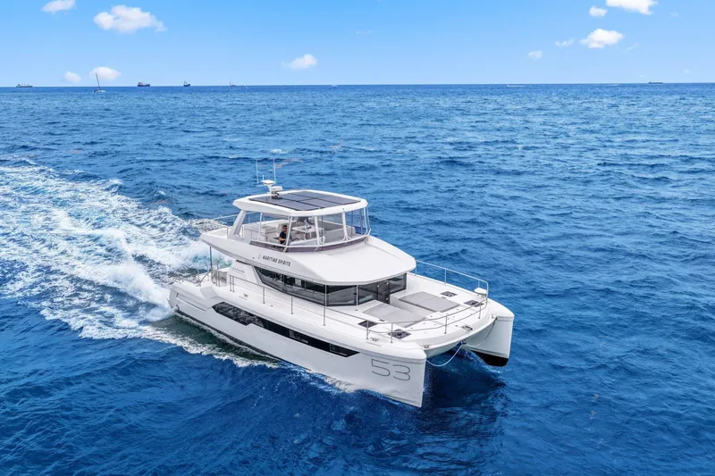 Slide: The Image of 2025 Leopard 53 Powercat cruising on open ocean under clear blue sky. - 10