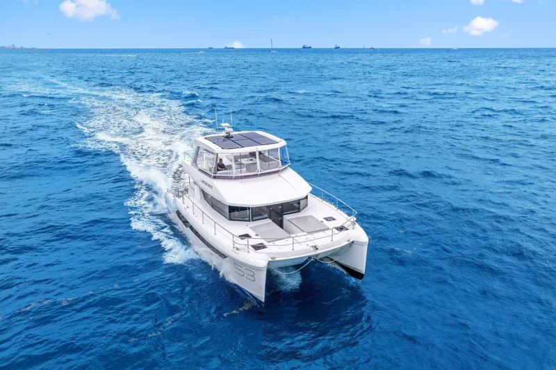 Slide: The Image of 2025 Leopard 53 Powercat cruising on open blue ocean under clear sky. - 11