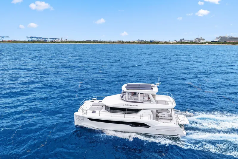 Slide: The Image of 2025 Leopard 53 Powercat cruising on blue ocean near coastline. - 13