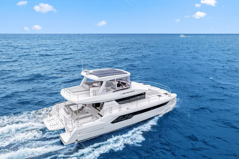 Slide: The Image of 2025 Leopard 53 Powercat cruising on open ocean under clear blue sky. - 15