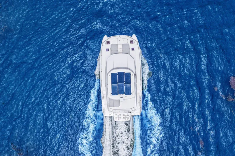 Slide: The Image of Aerial view of 2025 Leopard 53 Powercat cruising on vibrant blue ocean waters. - 16