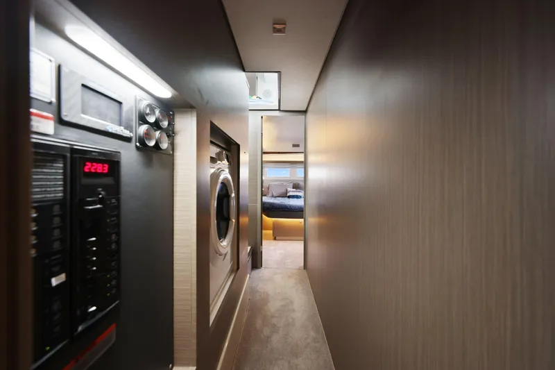 Slide: The Image of Narrow hallway inside 2025 Leopard 53 Powercat yacht, featuring modern appliances and cozy bedroom view. - 25