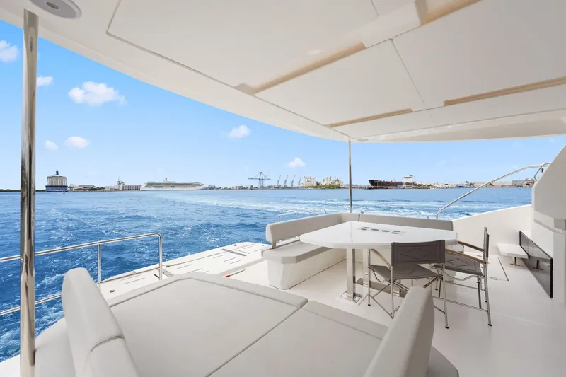 Slide: The Image of Luxurious 2025 Leopard 53 Powercat yacht with spacious deck overlooking serene ocean and harbor. - 36