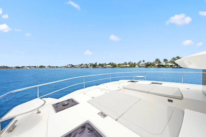 Slide: The Image of 2025 Leopard 53 Powercat yacht on serene blue waters, clear sky, and distant shoreline. - 44
