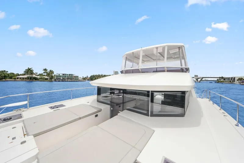 Slide: The Image of 2025 Leopard 53 Powercat yacht on serene water with clear blue sky. - 45