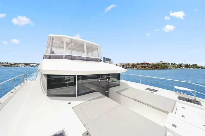 Slide: The Image of 2025 Leopard 53 Powercat yacht on serene blue waters, showcasing sleek design and spacious deck. - 46