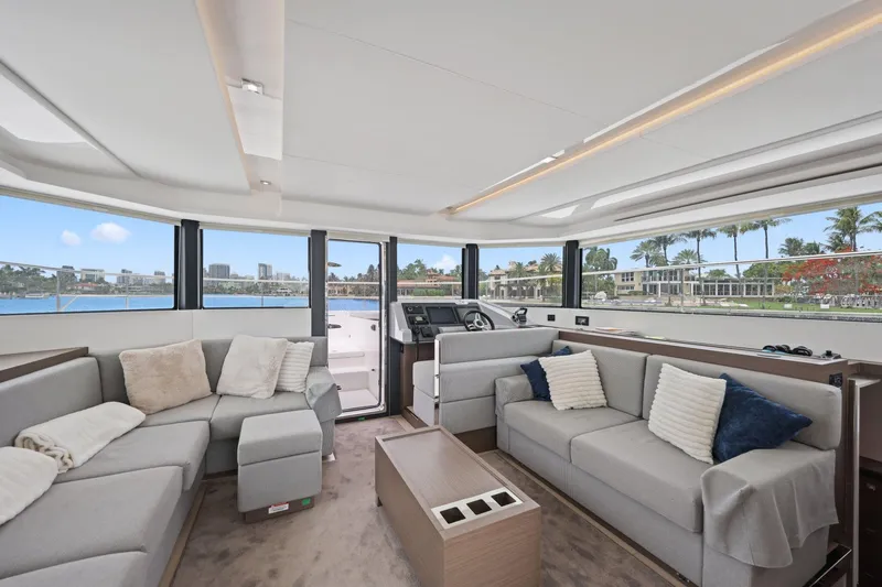 Slide: The Image of Luxurious interior of 2025 Leopard 53 Powercat yacht with plush seating and panoramic windows. - 55