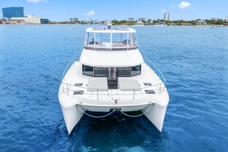 Slide: The Image of 2025 Leopard 53 Powercat yacht on calm blue waters, cityscape in background. - 6