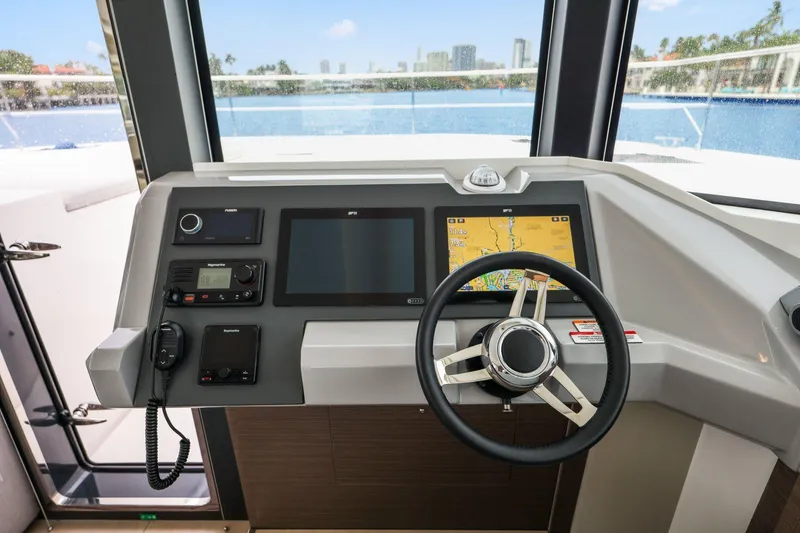 Slide: The Image of Helm of 2025 Leopard 53 Powercat with navigation screens and steering wheel. - 60