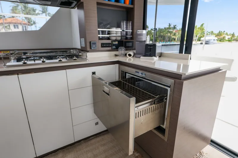 Slide: The Image of Modern kitchen on 2025 Leopard 53 Powercat yacht with open dishwasher drawer. - 64