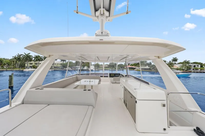 Slide: The Image of 2025 Leopard 53 Powercat yacht interior with spacious seating and modern amenities on a sunny day. - 67