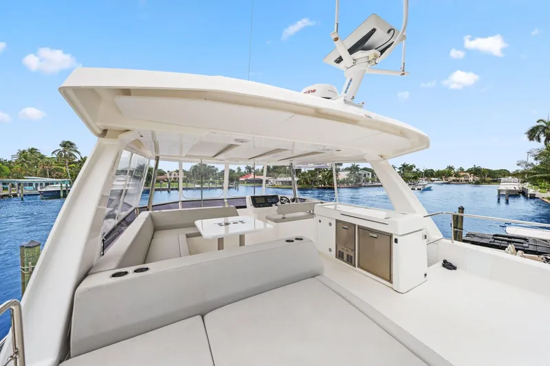 Slide: The Image of 2025 Leopard 53 Powercat yacht with spacious deck and modern amenities, docked by a scenic waterfront. - 69