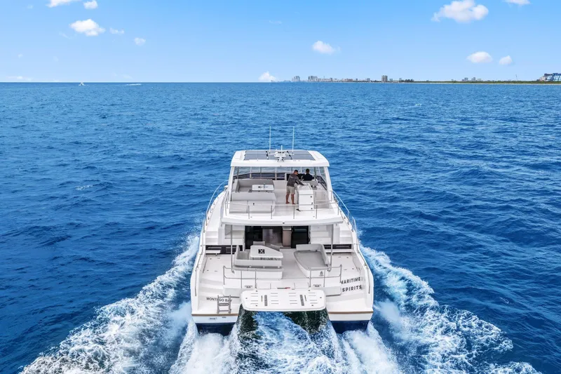 Slide: The Image of 2025 Leopard 53 Powercat cruising on open sea under clear blue sky. - 7