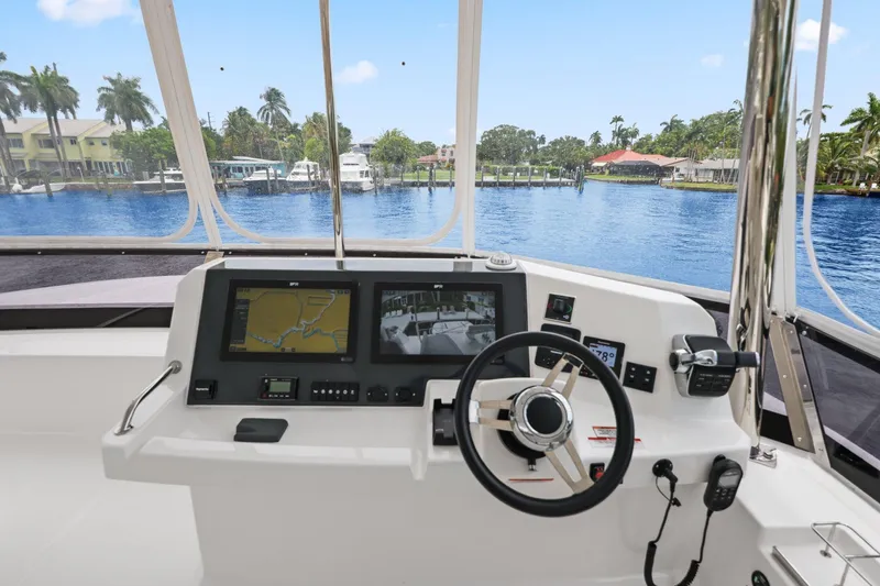 Slide: The Image of Helm of 2025 Leopard 53 Powercat with navigation screens and waterfront view. - 74