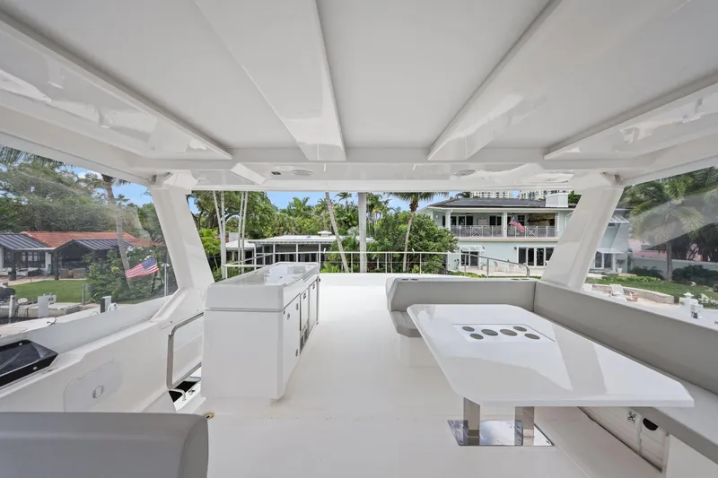 Slide: The Image of Spacious deck of 2025 Leopard 53 Powercat yacht with modern seating and outdoor kitchen. - 76