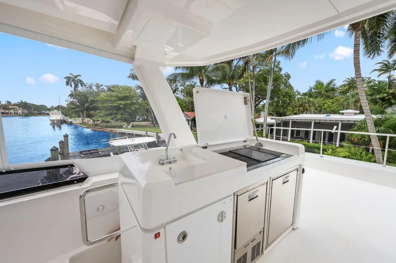 Slide: The Image of Outdoor kitchen on 2025 Leopard 53 Powercat yacht with scenic waterfront view. - 78