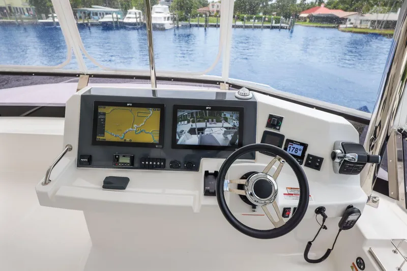 Slide: The Image of Cockpit of 2025 Leopard 53 Powercat with navigation screens and steering wheel. - 79