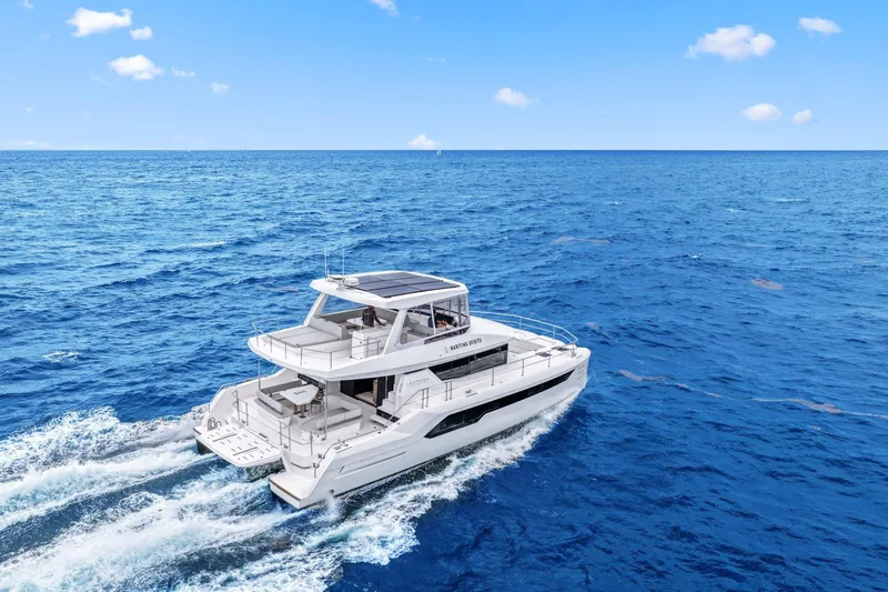 Slide: The Image of 2025 Leopard 53 Powercat cruising on open ocean under clear blue sky. - 8