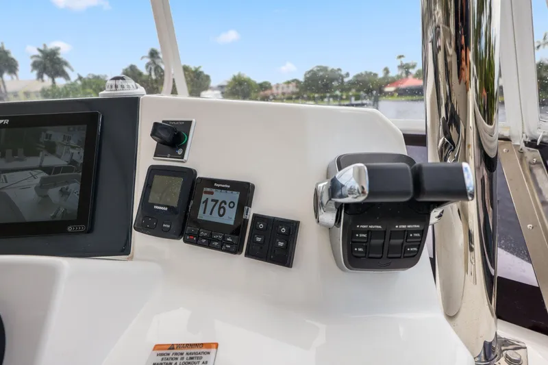 Slide: The Image of Control panel of 2025 Leopard 53 Powercat with navigation instruments and throttle. - 82