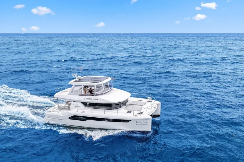 Slide: The Image of 2025 Leopard 53 Powercat cruising on open blue ocean under clear sky. - 9
