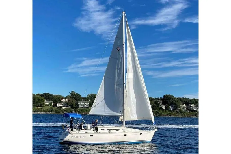 The Image of 1997 Jeanneau Sun Odyssey 36.2 sailboat cruising on a sunny day with clear blue skies. - 0